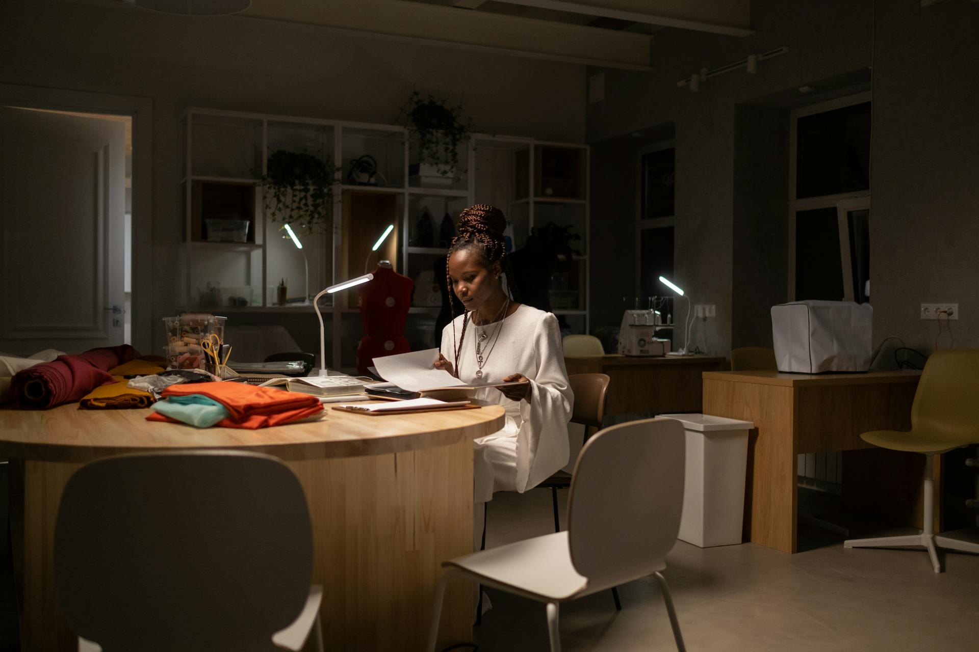 young-african-american-fashion-designer-working-late-in-sewing-work-space