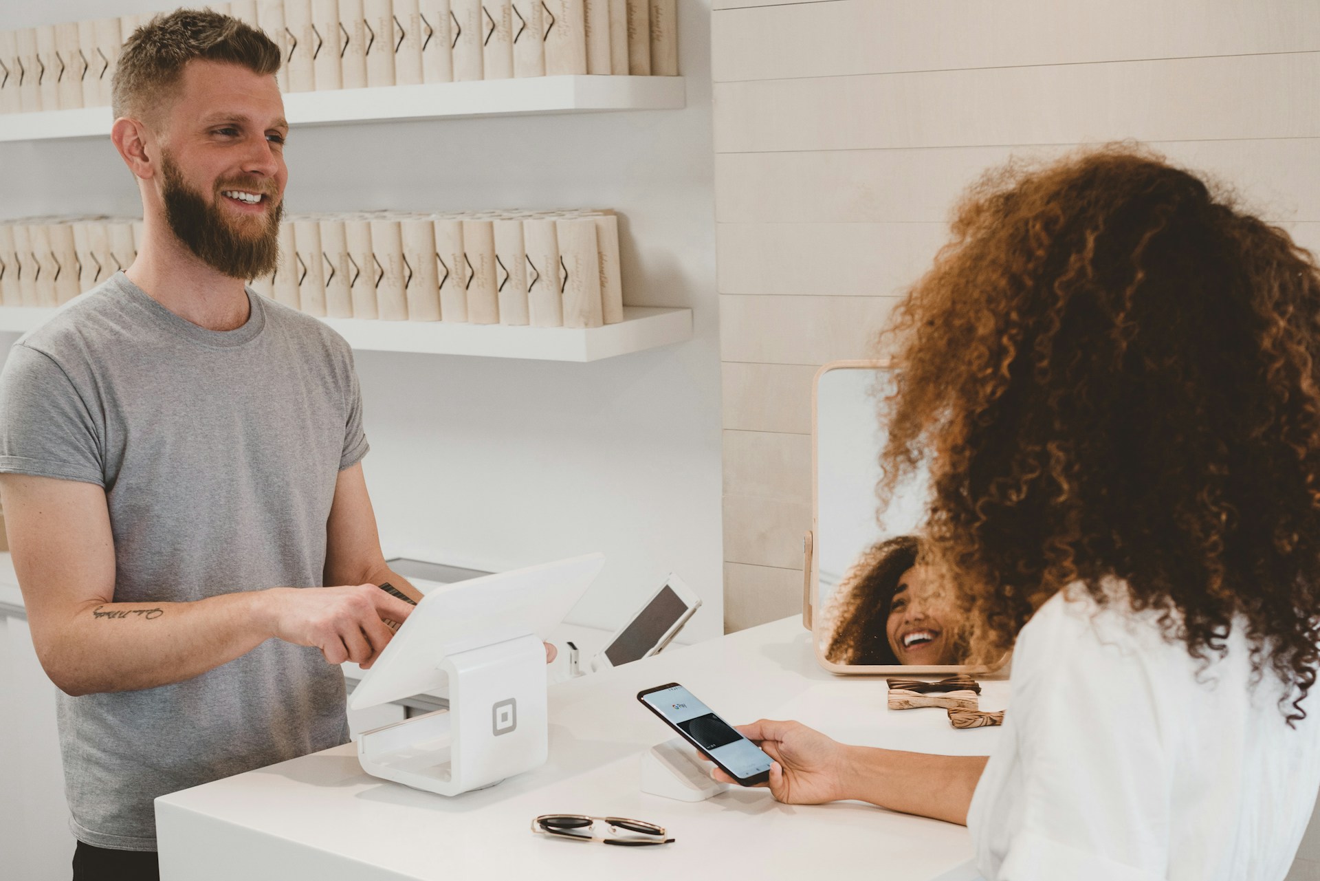 man-in-grey-crew-neck-t-shirt-smiling-to-woman-on-counter