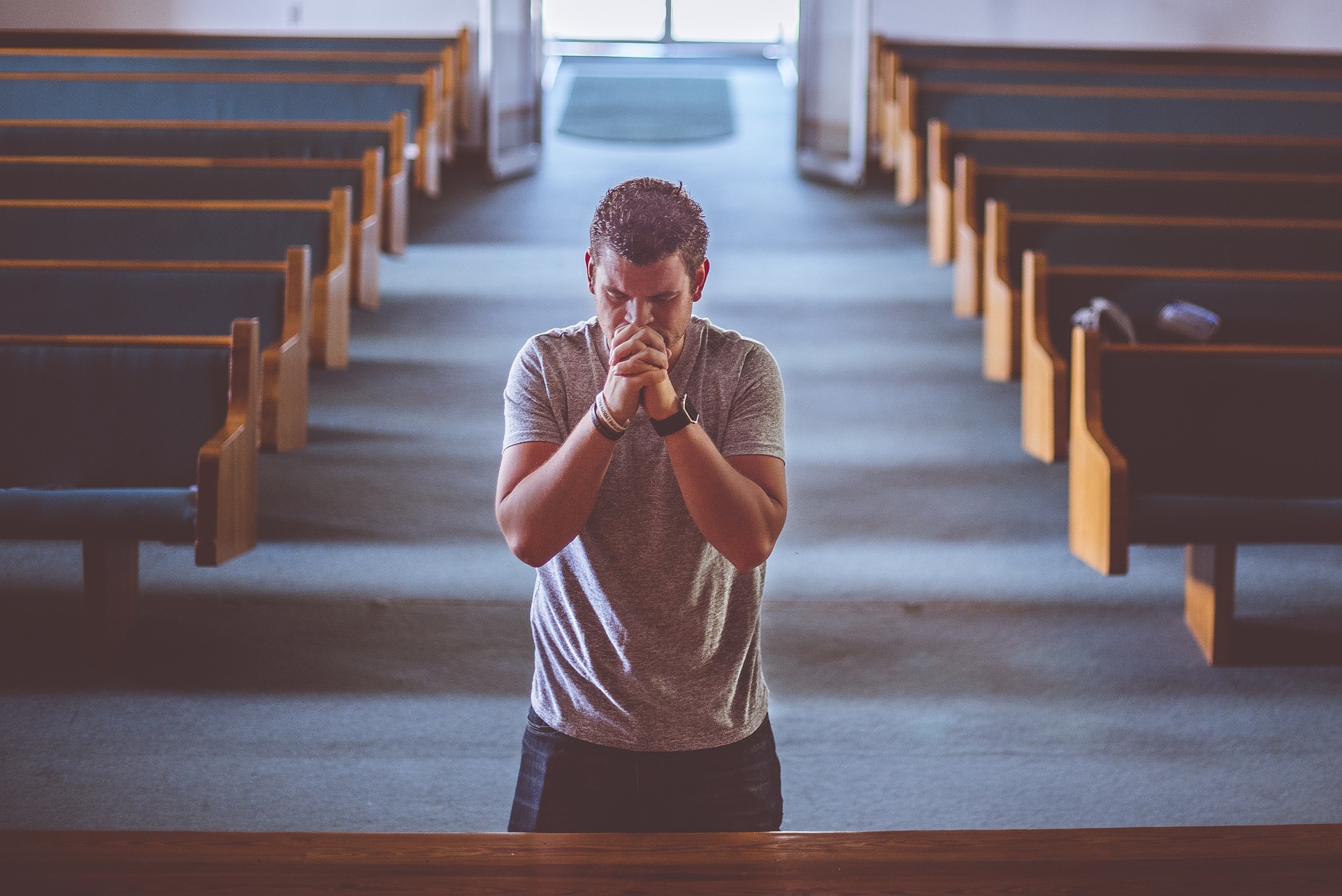 man-praying-church-prayer-pews