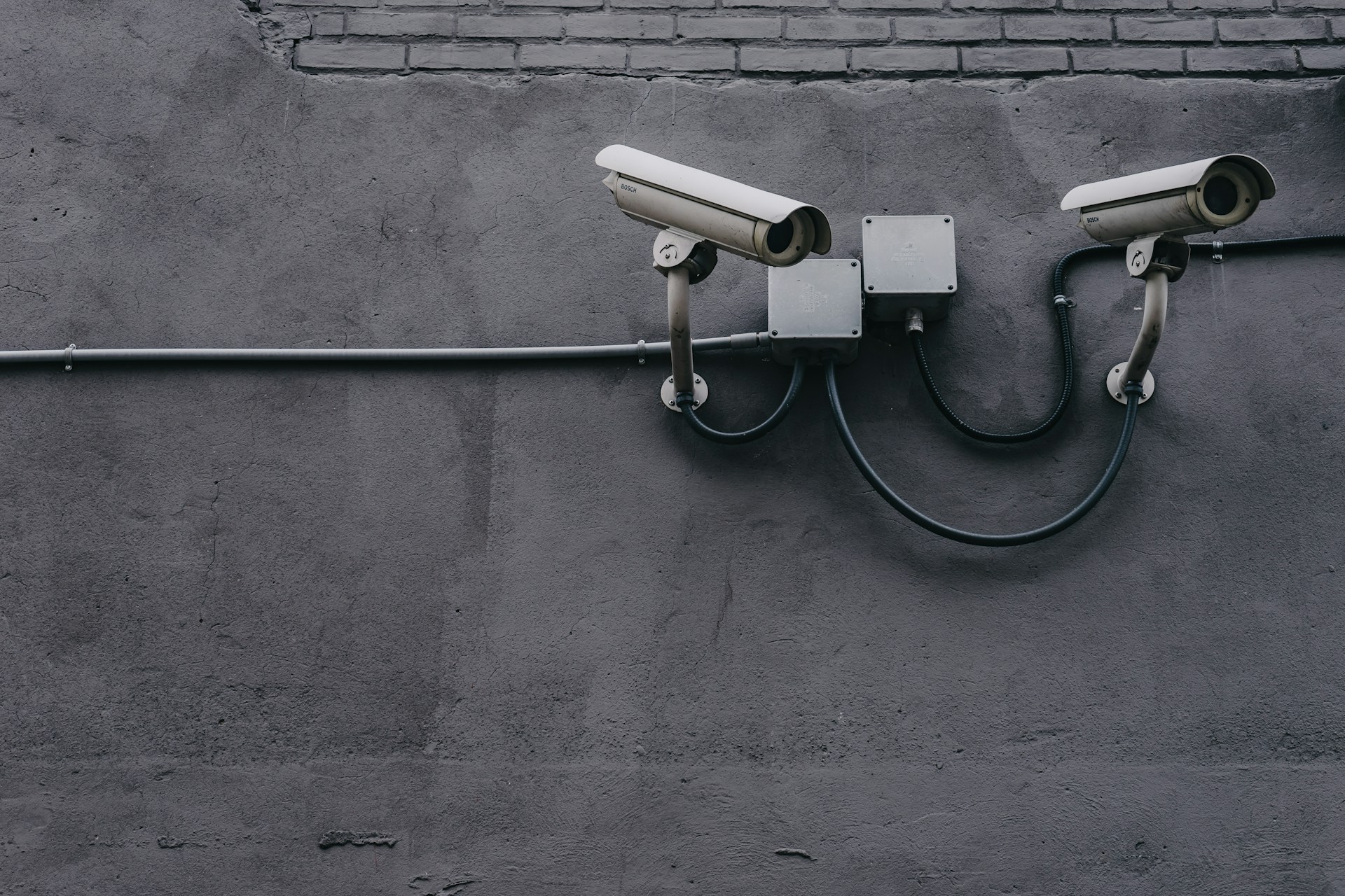 two-bullet-surveillance-cameras-attached-on-wall