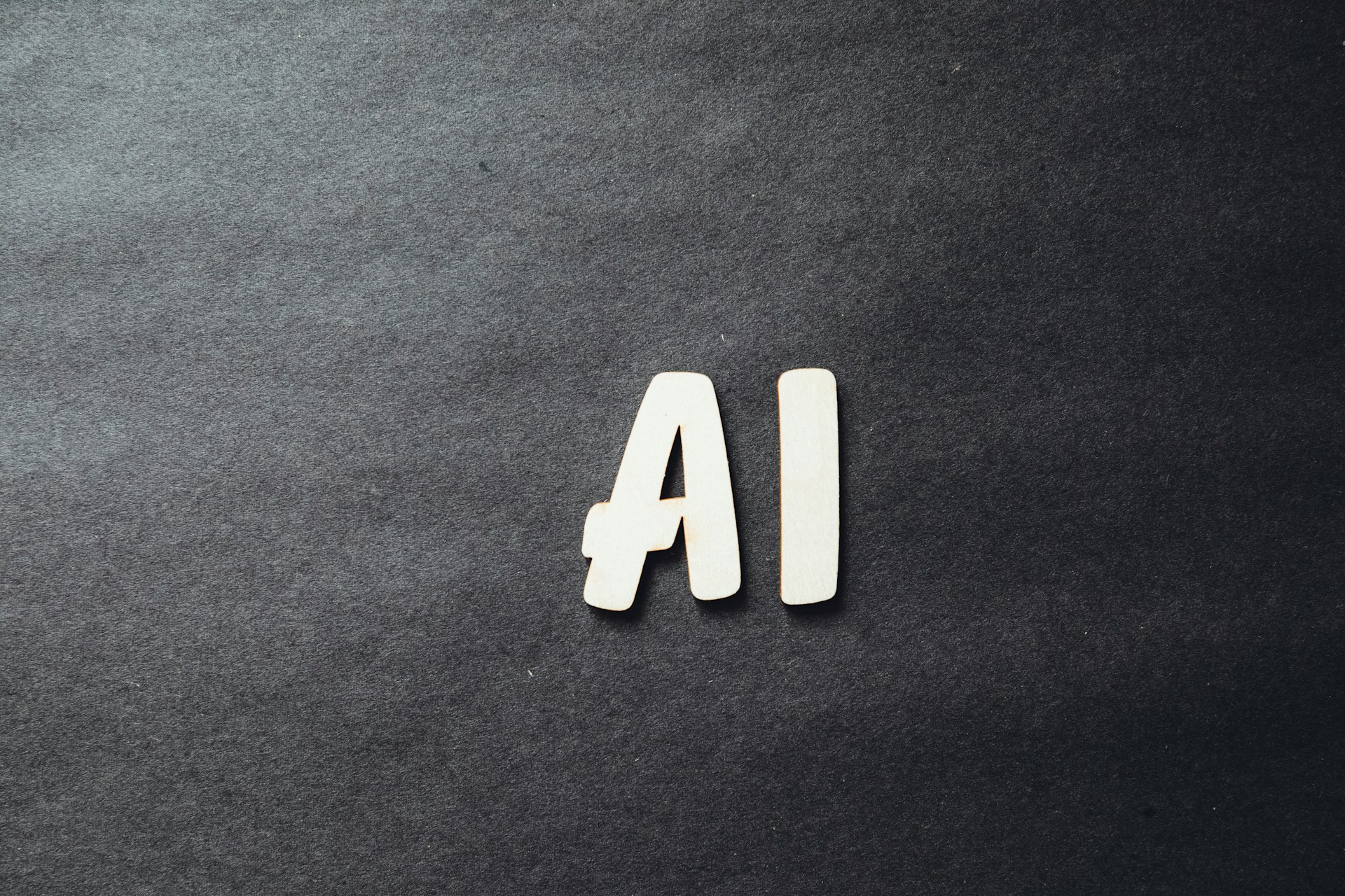 the-word-ai-spelled-in-white-letters-on-a-black-surface