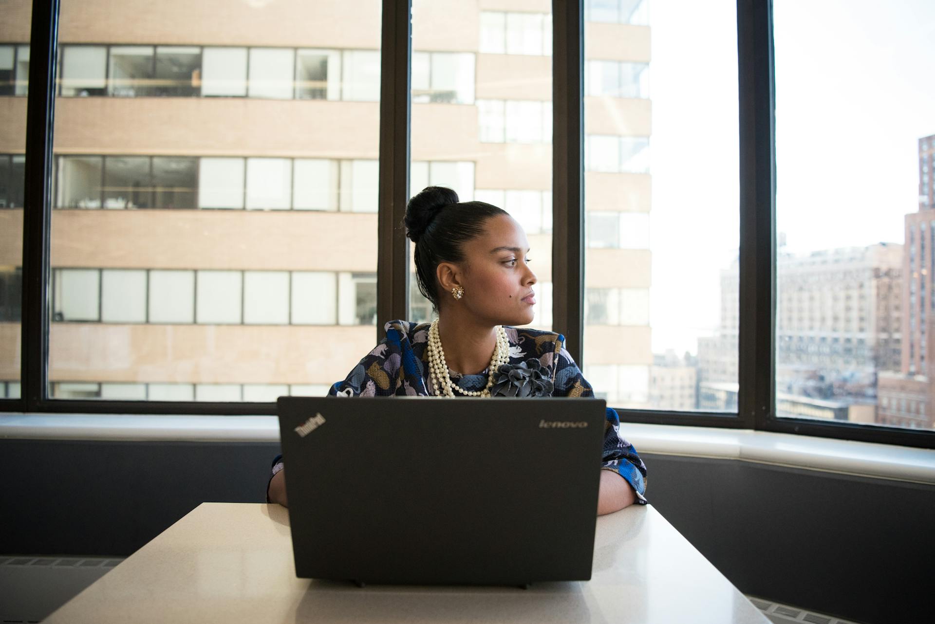 woman-sits-in-front-of-black-laptop-computer