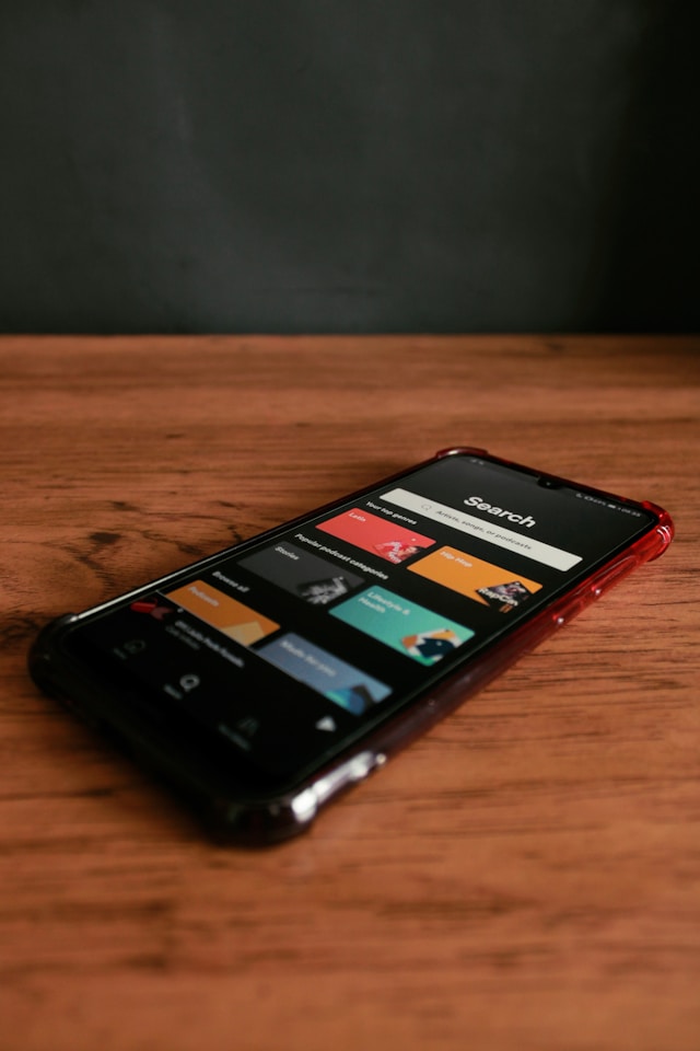 black-iphone-4-on-brown-wooden-table