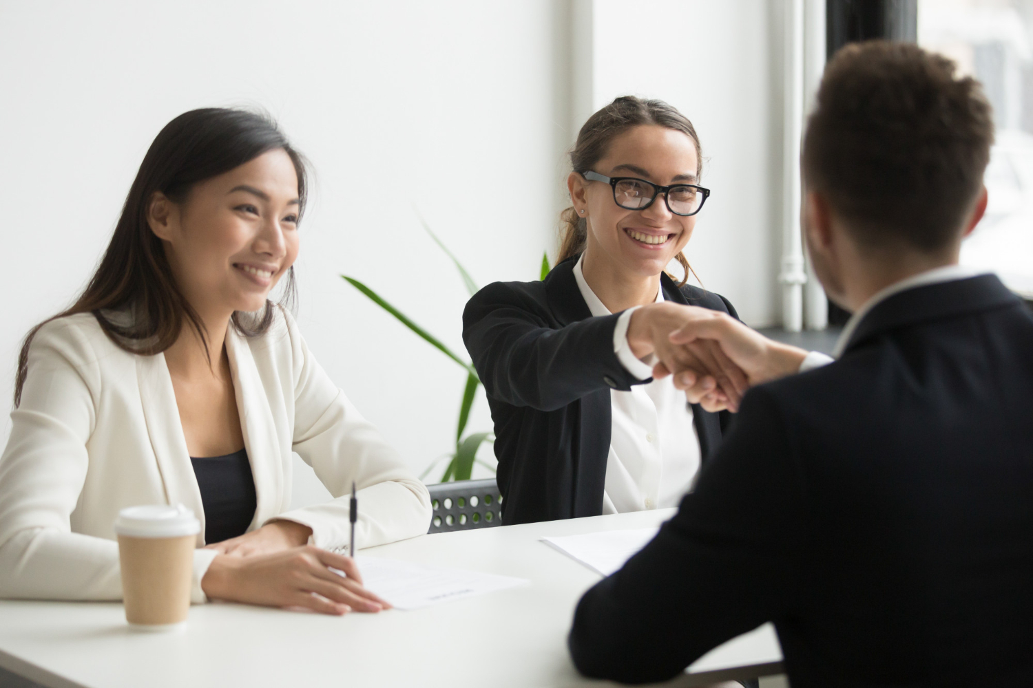 businessman-shaking-hand-female-coworker-company-meeting