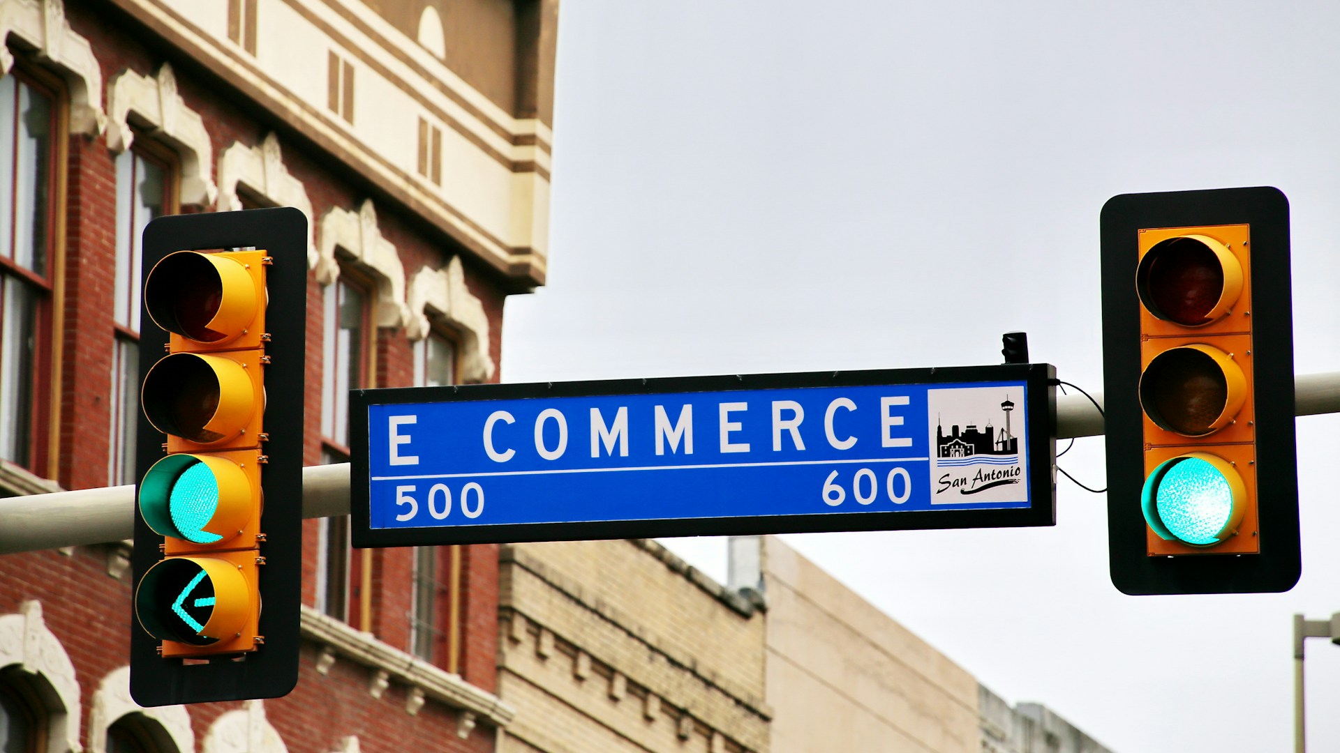 a-traffic-light-with-a-street-sign-hanging-from-its-side