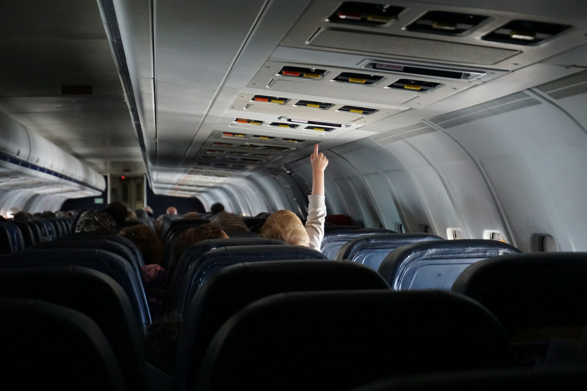woman-raising-her-hand-on-passenger-seat