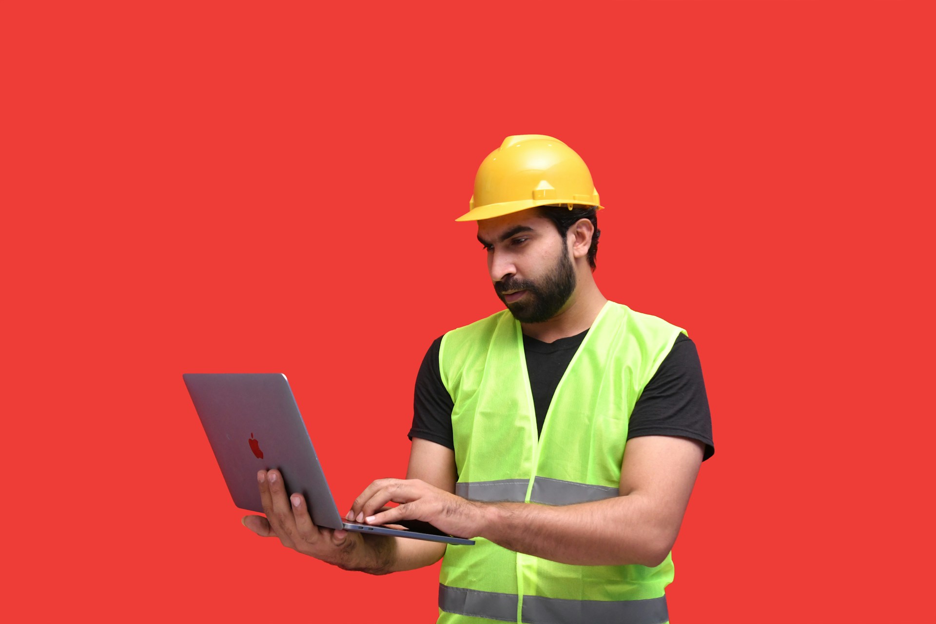 a-man-in-a-yellow-hard-hat-holding-a-tablet