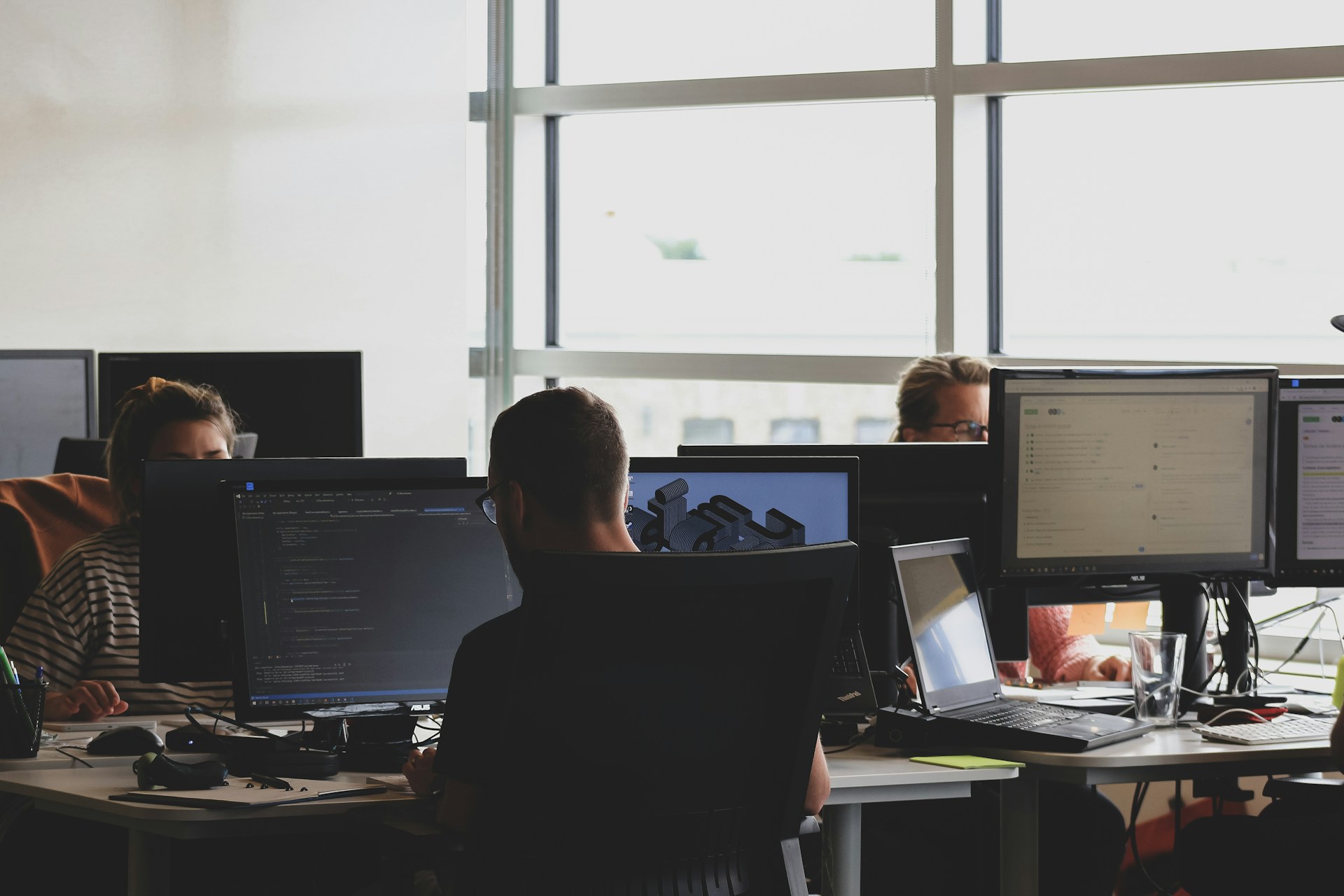 people-sitting-on-chair-in-front-of-computer-monitor