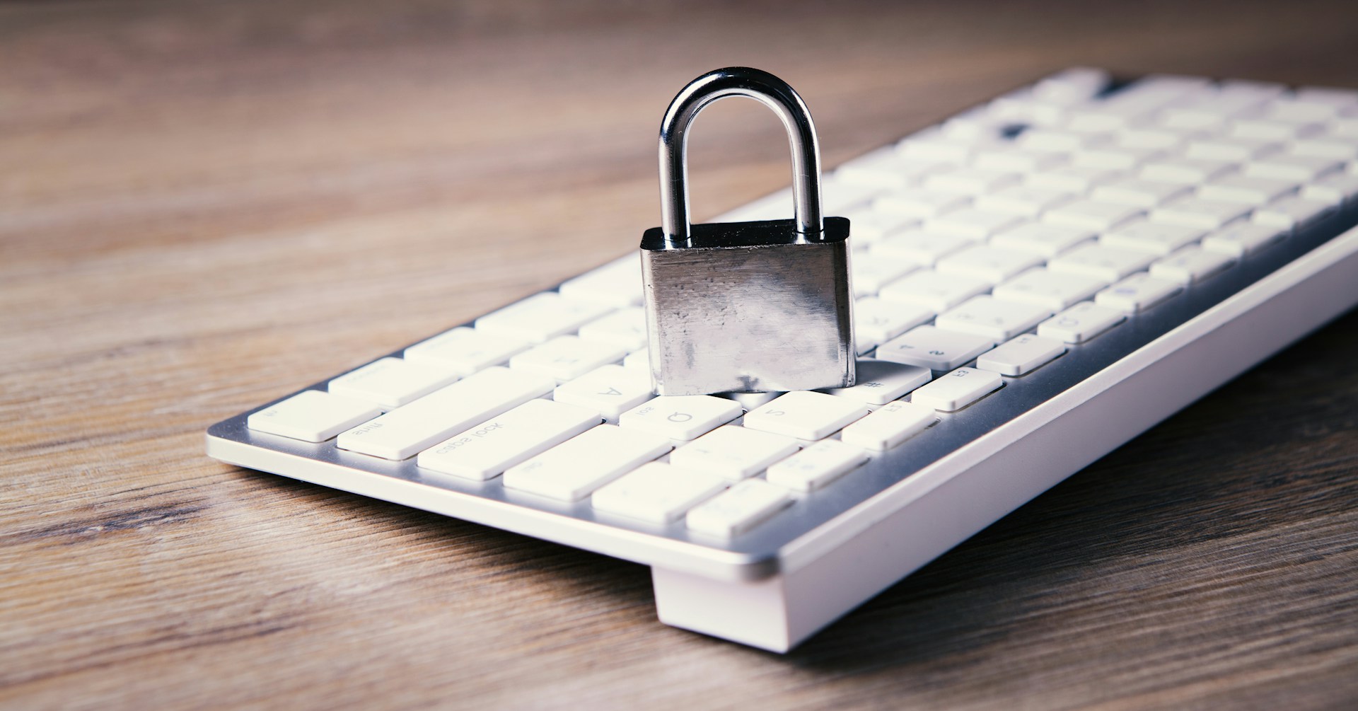a-computer-keyboard-with-a-padlock-on-top-of-it