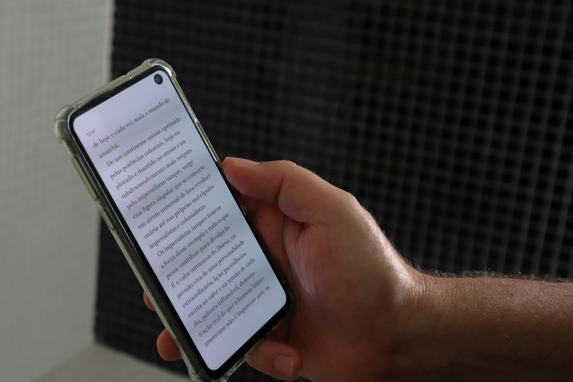 a-person-holding-a-smart-phone-with-a-book-on-the-screen