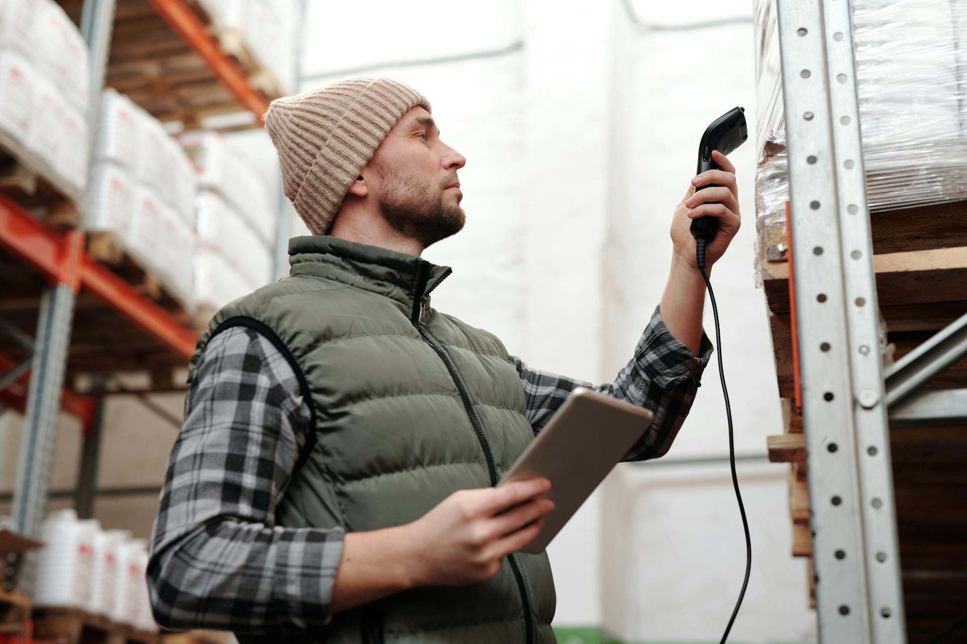 photo-of-a-man-scanning-products-in-a-warehouse