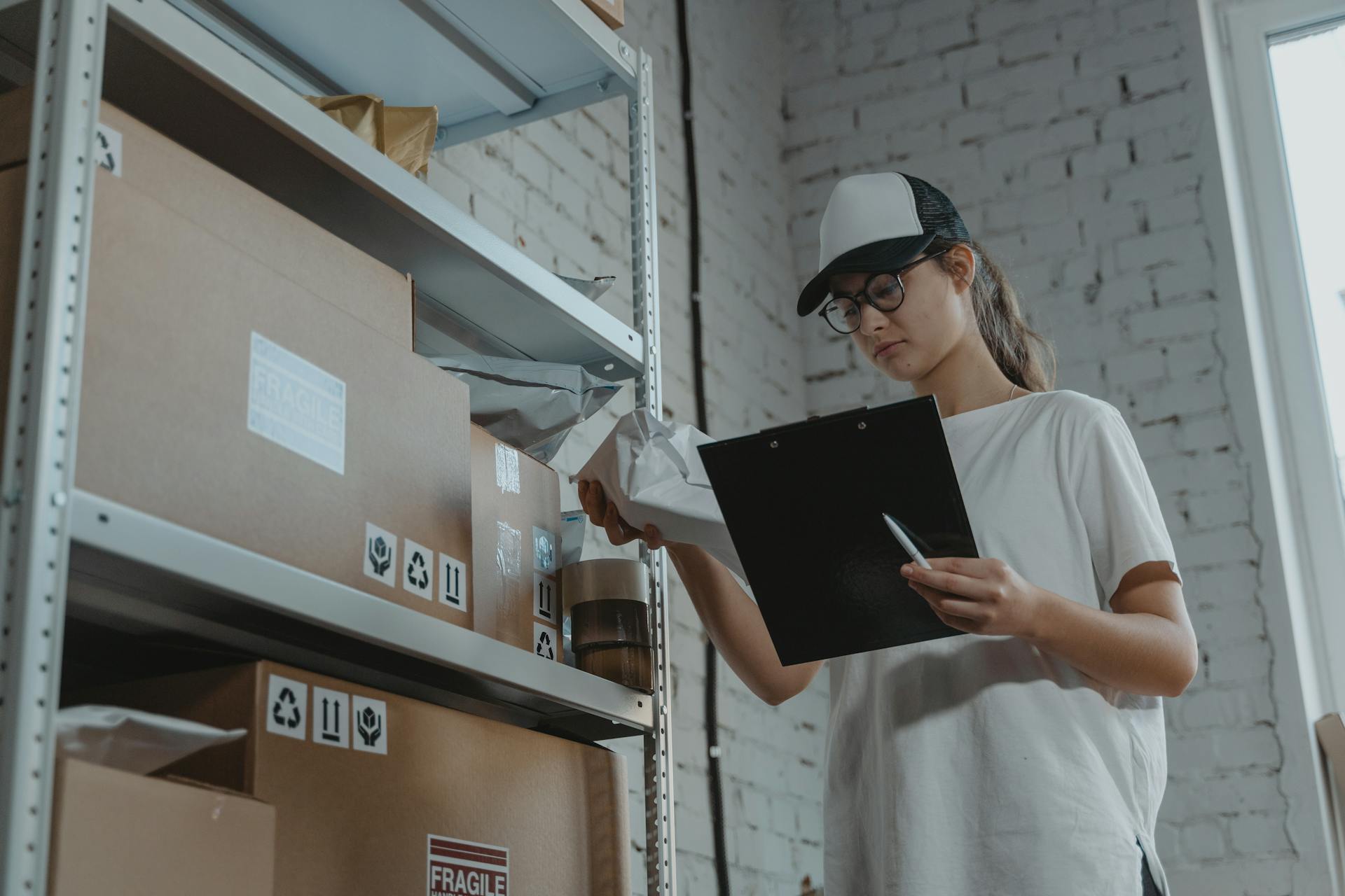 woman-in-white-t-shirt-holding-black-laptop-computer