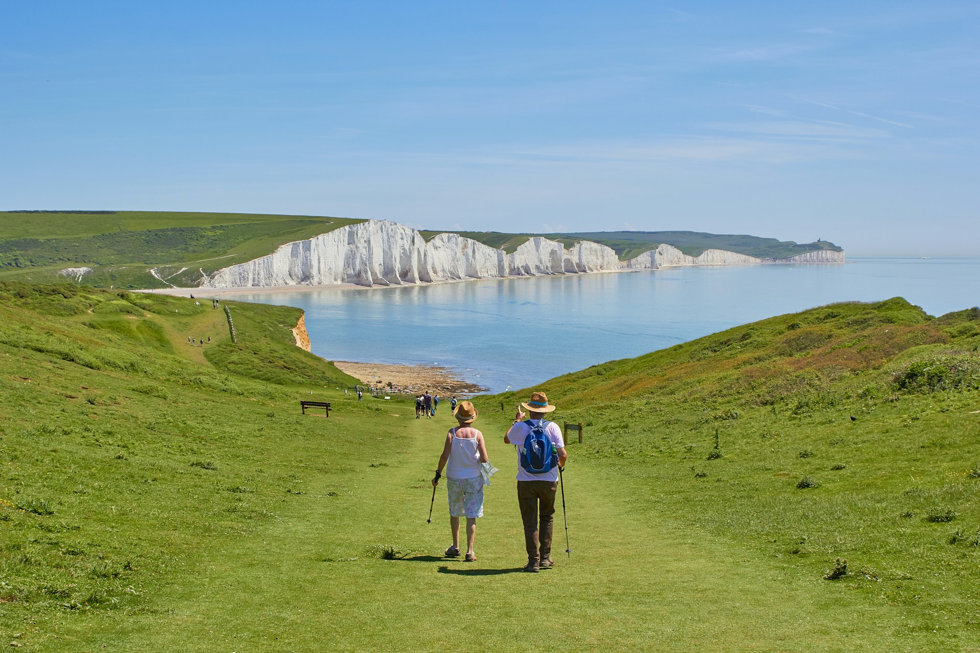 2-men-standing-on-green-grass-field-near-body-of-water-during-daytime