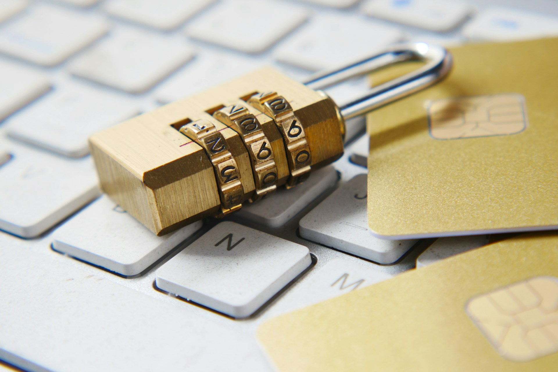 a-golden-padlock-sitting-on-top-of-a-keyboard