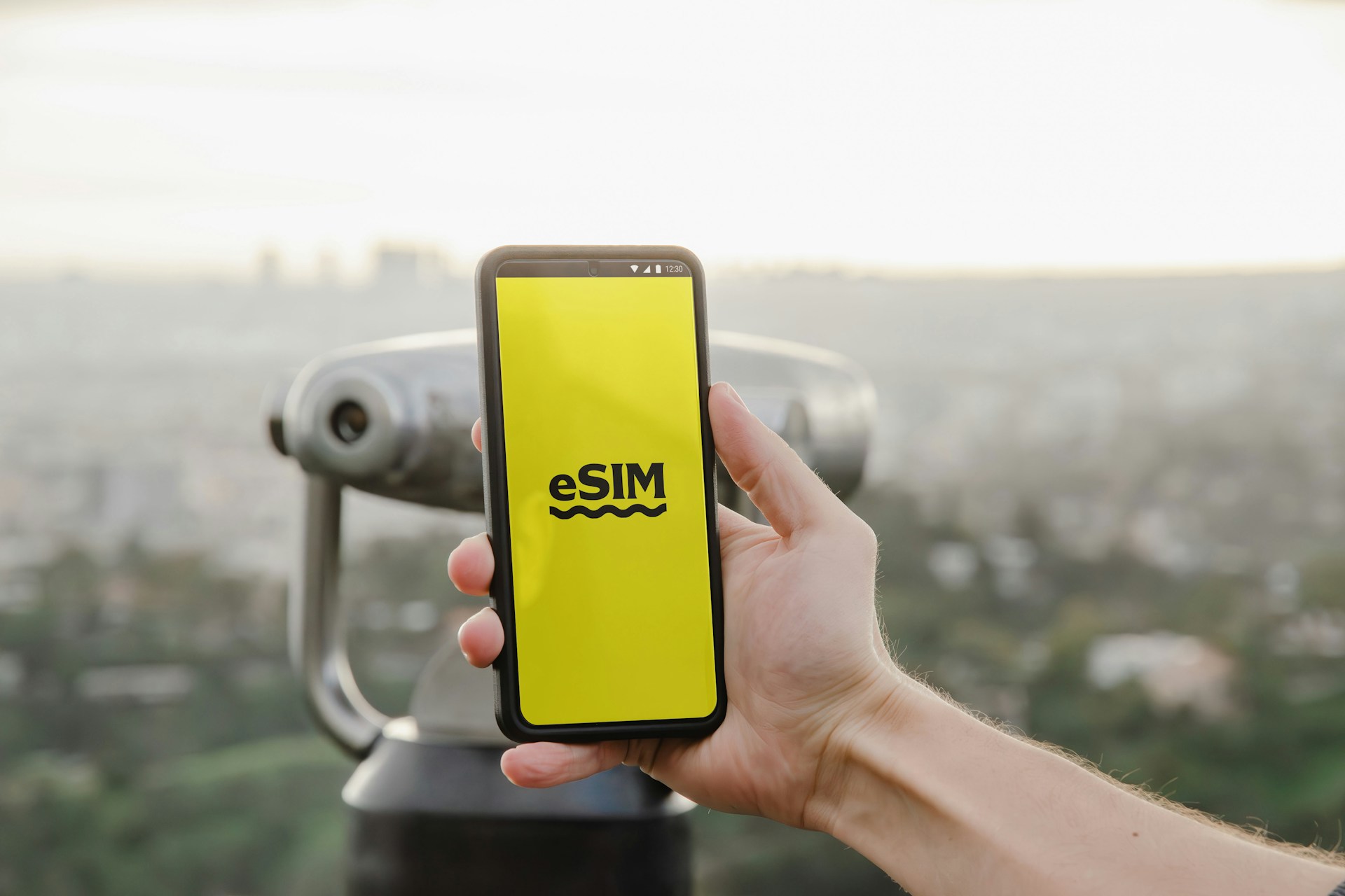 a-person-holding-up-a-cell-phone-with-a-logo-on-it