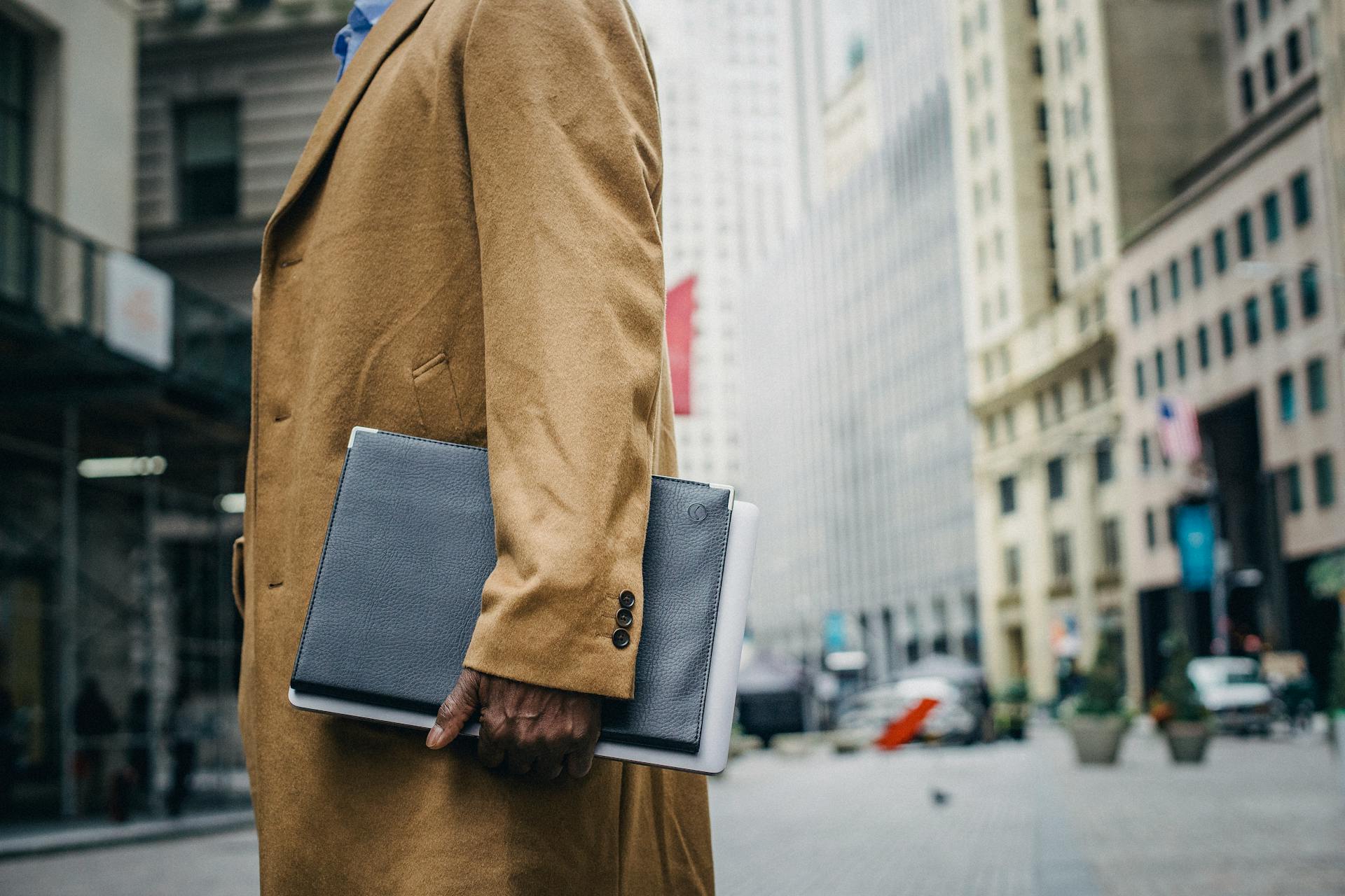 black-man-with-folder-in-overcoat